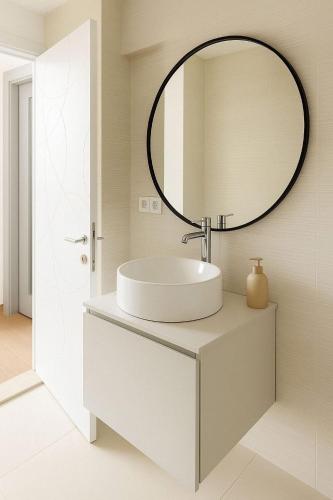 a bathroom with a sink and a mirror at Panoramic Sea Apartment in Kvariati