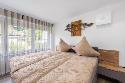 a bedroom with a large bed and a window at Ferienwohnung Marina in Stockach