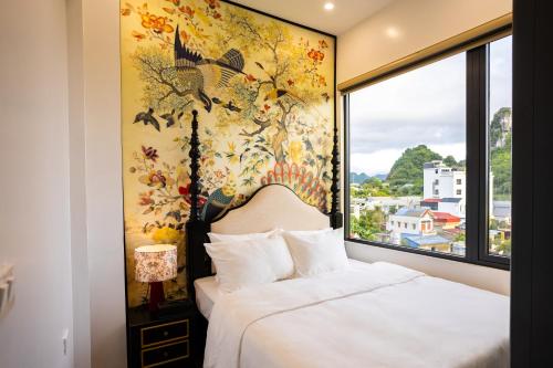 a bedroom with a bed and a large window at PG indochine Mộc Châu in Sơn La