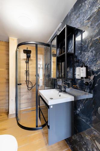 a bathroom with a sink and a shower at Stejkárna Špičák in Špičák