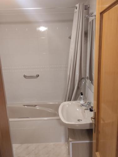a bathroom with a tub and a sink and a shower at Eclipse in Olvega
