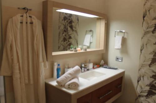 a bathroom with a sink and a shower with a mirror at HILTON Residence of LUXURY 5 STARS apartment F1 in Baku