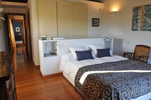 a bedroom with a large bed with blue pillows at Etxauri Palace for art lovers in Echauri
