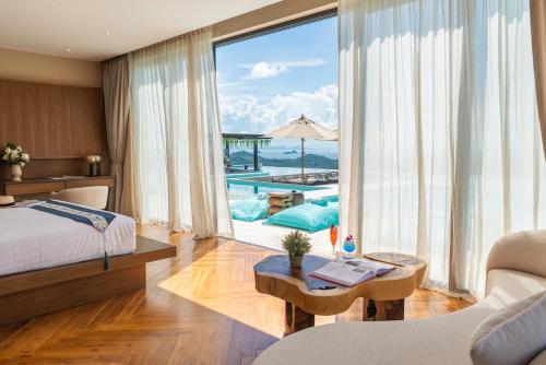 a bedroom with a bed and a view of a pool at Z Exquisite Koh Samui Domain with Infinity Pool in Nathon Bay
