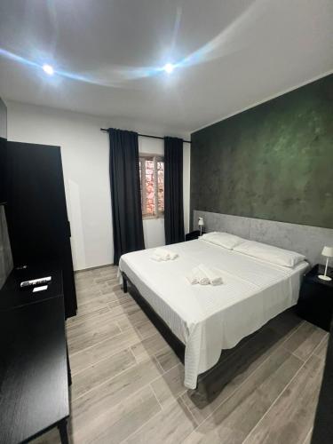 a bedroom with a large bed and a green wall at Affittacamere Plaza in Pietracatella