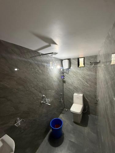 a bathroom with a toilet and a sink at Tangerine House in Canacona