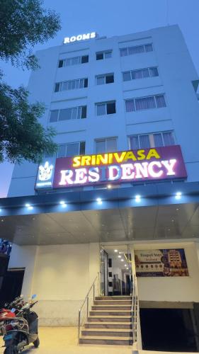 a building with a sign on the front of it at Tirupati Stays in Tirupati