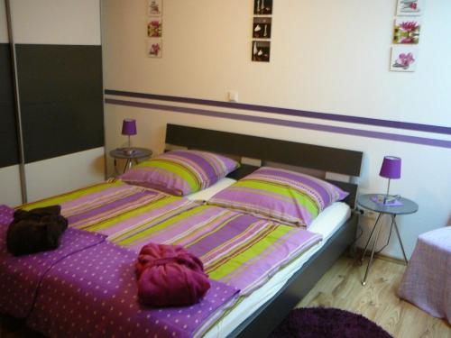 a bedroom with a bed with purple sheets and pillows at Ferienwohnung Waldraff in Ostrach