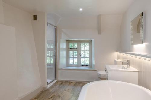 a white bathroom with a toilet and a sink at 5 Bed in Bishops Lydeard oc-b45427 in  Liscombe