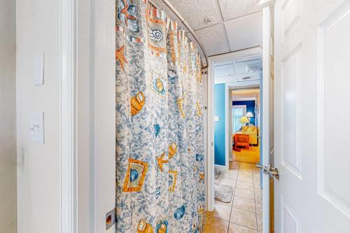 a hallway with a door with a wall with a mural at White Marlin 303B in Ocean City