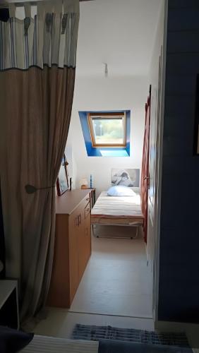 a small room with a bed and a window at Sterne pierregarin 2kms de la plage in Séné