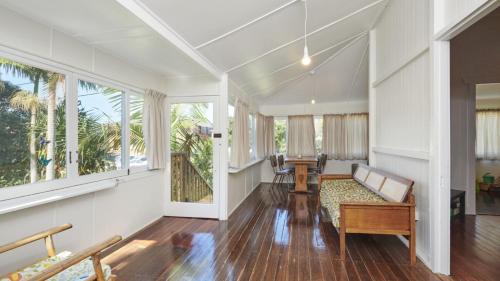 an empty living room with a couch and windows at Pinchin's Place in Brunswick Heads