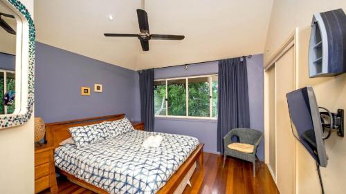 a bedroom with a bed and a ceiling fan at MiaCasa in New Brighton