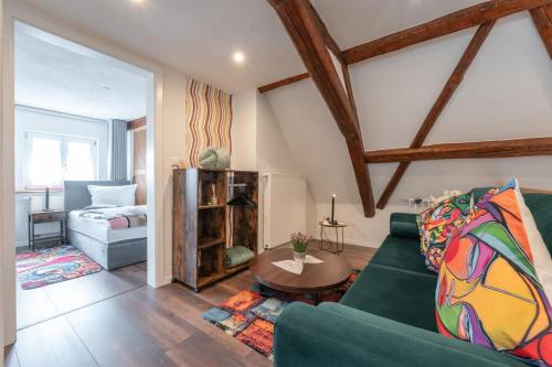 a living room with a green couch and a table at A9 City Boardinghouse ,WiFi , Parking, VAT Invoice in Günzburg
