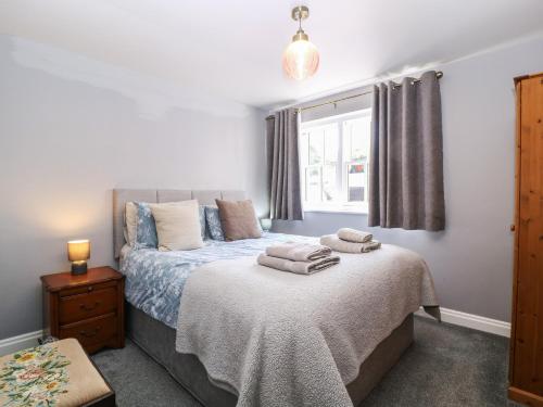 a bedroom with a bed with towels on it at 19 Lion Street in Hereford