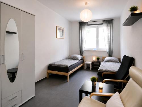 a living room with a bed and a couch at Apartments am Heimbach EG rechts in Kassel