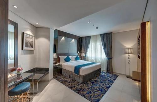 a hotel room with a bed and a desk at Hotel The De - Pacific Suites Near Delhi IGI Airport in New Delhi
