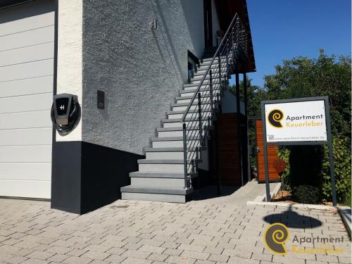 a set of stairs next to a building with a sign at Apartment Keuerleber in Holzmaden