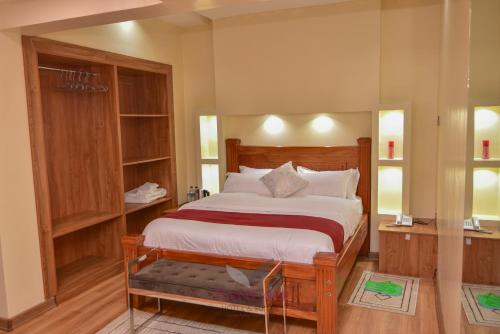 a bedroom with a large bed in a room at Paneah hotel and suites in Nairobi