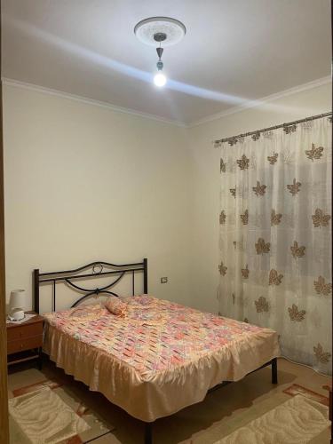a bedroom with a bed and a ceiling at Stone House Leskovik in Leskovik