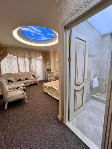 a room with a bathroom with a shower and a bedroom at Agava Tbilisi in Tbilisi City