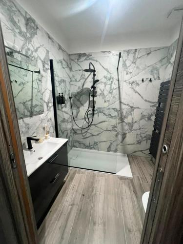 a bathroom with a marble shower and a sink at Affittacamere Plaza in Pietracatella