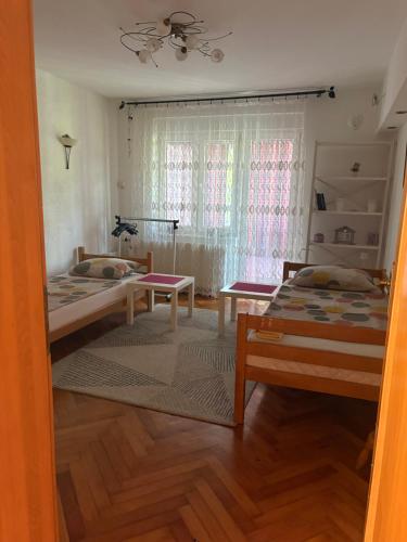 a bedroom with two beds and a window at Una Mirage in Bihać