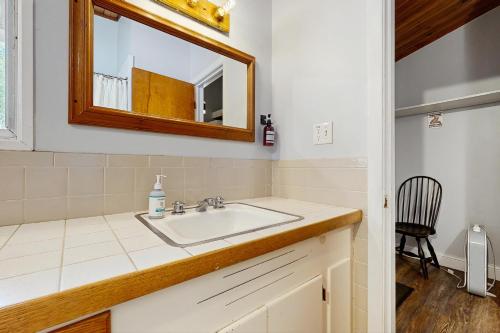 a bathroom with a sink and a mirror at Griffin Chalet 5 in Stowe