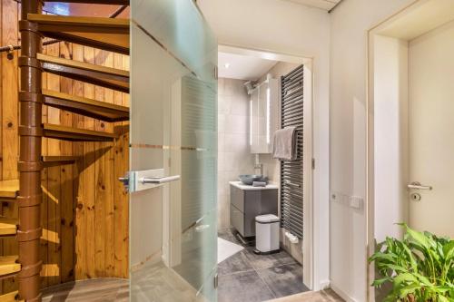 a glass shower door in a bathroom with a sink at Ferienwohnung Stillblick in Gersthofen