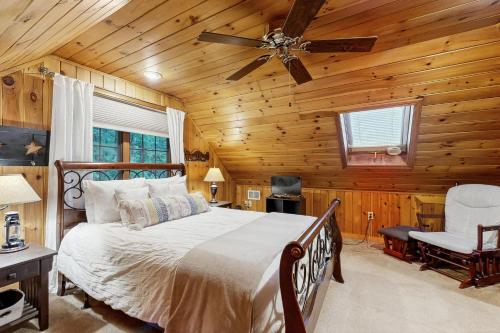 a bedroom with a bed and a ceiling fan at Four Seasons at the Lake in Bridgton