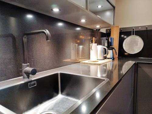 a kitchen with a stainless steel sink in a kitchen at View Apartments in Åre