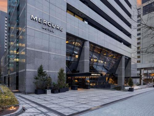 a large building with a sign on the side of it at Mercure Tokyo Hibiya in Tokyo