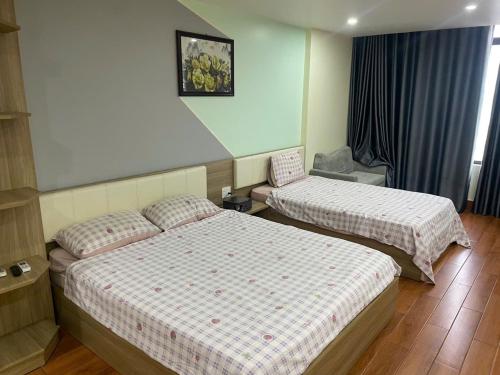 a hotel room with two beds in a room at Flick Zone Trung Lực in Lực Hánh