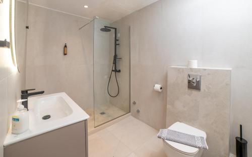 a bathroom with a shower and a toilet and a sink at Achilleas Hotel in Parga