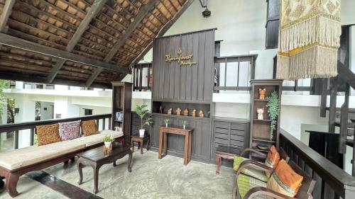 a living room with a couch and a table at Sunday Rainforest Chiangmai Hotel in Chiang Mai