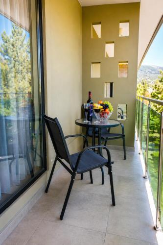 a table and chair on a balcony with a view at Hotel Gareji Kakheti in Sagarejo