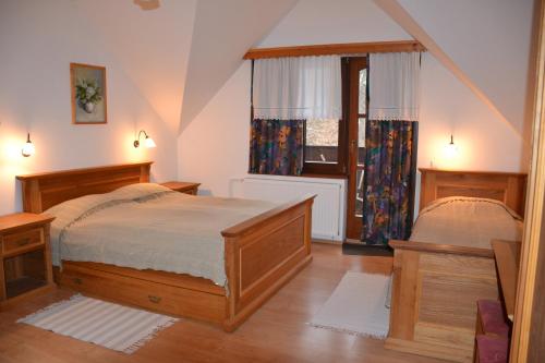 a bedroom with a bed and a window at Turisticna Kmetija Pudvoi in Bizeljsko