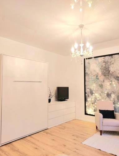 a living room with a white door and a tv at Muna Living in Riga