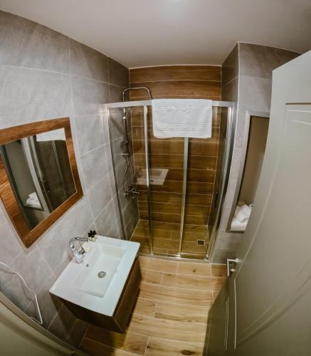 a bathroom with a sink and a shower at Karasu Riva Otel in Karasu