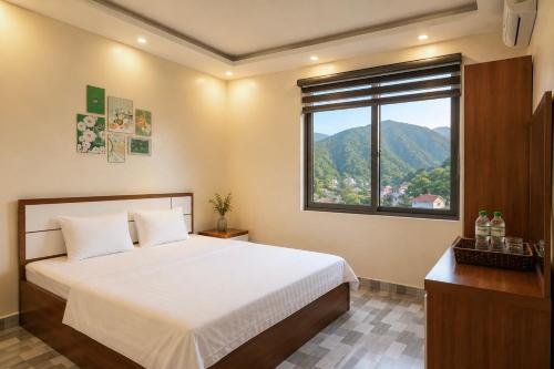 a bedroom with a large bed and a window at Cat Ba Sky Home in Cat Ba