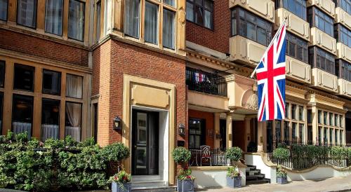 a british flag flying in front of a building at The Capital Hotel, Apartments & Townhouse - Small Luxury Hotels of The World in London
