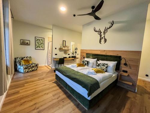 a bedroom with a bed with a deer head on the wall at Gasthof Schloss Hubertus in Erfurt