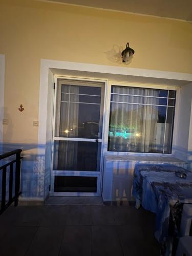 a room with a window and a bed in a room at Irene's Sunny apartment in Limnos in Néa Koútali