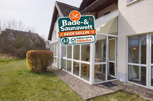 a sign for a restaurant in front of a building at Strandhaus Lobbe, App 04 - Bade- & Saunawelt täglich inklusive in Lobbe