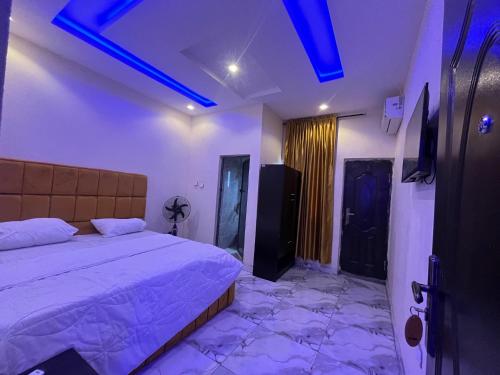 a bedroom with a bed and a television in it at Etsuko hotel and suites world city in Atan