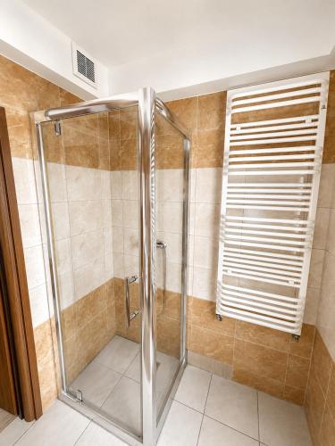 a shower with a glass door in a bathroom at Villa AGNAT in Gdańsk