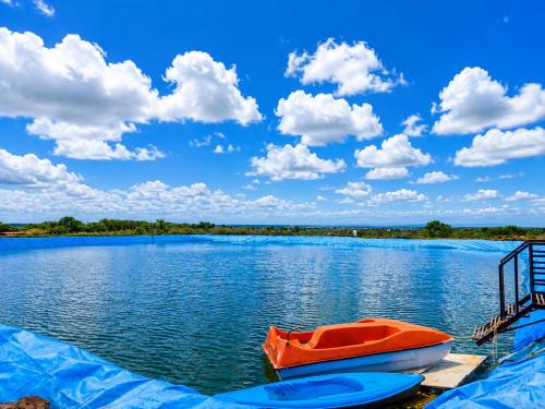 a boat sitting on the water on a lake at Royal Villa Resort in Sāngli
