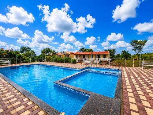 a swimming pool in front of a house at Royal Villa Resort in Sāngli