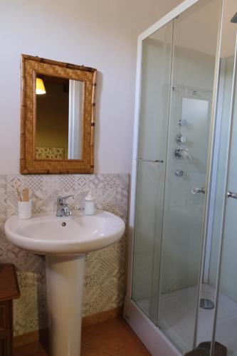 a bathroom with a sink and a shower at Antico Frantoio Rooms in Sambuca di Sicilia