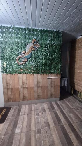 a wall with a painting of a peacock on it at Lo de Julia in Formosa